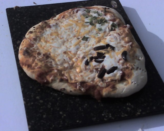 firstpizzaoncuttingboard.jpg