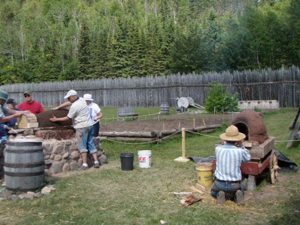 clay oven form on left and clay oven on wagon at right